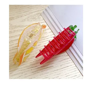 Close-up of carrot-shaped acrylic hair claws with vibrant colors and gold springs