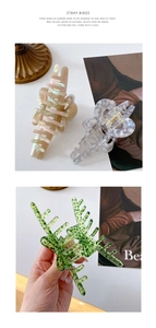 Detail showing high-quality acetate hair claws in marble and leopard prints with bow design