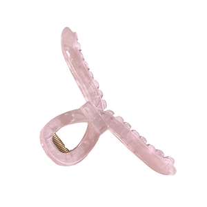 Pink translucent resin hair claw clip with ice crack texture and golden metal spring