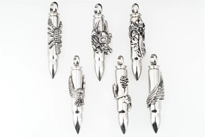 Detailed close-up of six bullet-shaped steel pendants with gothic embossed carvings