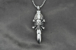 Detail of punk bullet pendant with skull and wings on a silver box chain necklace