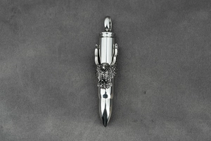 Macro detail of silver bullet pendant featuring an intricate eagle relief on steel