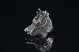 Macro detail of vintage punk wolf head ring with red gem eyes and aged metal scales