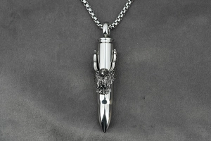 Detail of silver bullet pendant featuring an eagle head design on a steel pearl chain