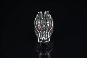 Macro shot of a retro punk wolf head ring featuring red zircon eyes and textured silver finish
