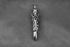 Macro detail of gothic bullet pendant featuring intricate sword and totem engravings