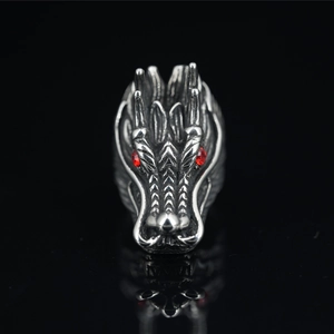 Punk wolf head ring in vintage steel with red crystal eyes on a reflective black background