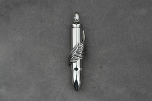 Detailed close-up of a silver bullet pendant featuring a finely carved metal wing design