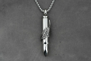Detail of bullet-shaped pendant with a delicate silver feather wing and steel chain