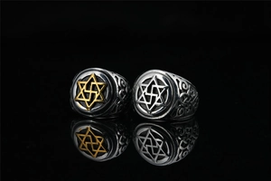 Macro shot of retro star and religious symbol engravings on polished titanium steel rings