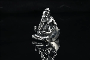 Macro detail of retro stainless steel Ganesha ring with vintage oxidized finish and intricate carving