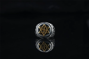 Macro detail of vintage titanium steel hexagram signet ring with engraved band patterns