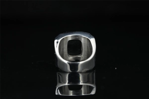 Macro view showing the black gemstone setting and polished inner steel band