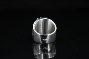 Macro view of men's titanium ring featuring inner wall details and dragon claw texture