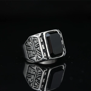 Vintage titanium steel ring for men featuring a rectangular black gemstone and relief texture