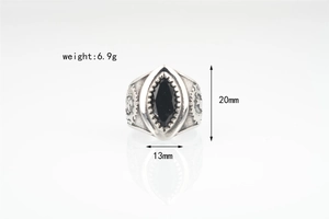 Close-up of vintage punk ring with black marquise gem and detailed gear engravings