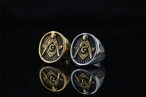 Macro detail of Freemasonry eye of providence rings in gold and silver steel finish