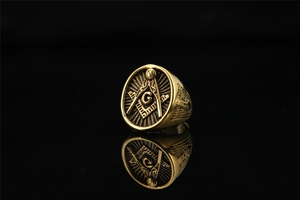 Detailed macro view of golden Masonic ring featuring Freemasonry symbol and vintage engraving