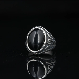 Vintage Mayan style titanium steel ring with large oval black gemstone and floral carvings
