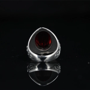 Vintage Mayan style stainless steel ring with a large red garnet stone and ornate carving