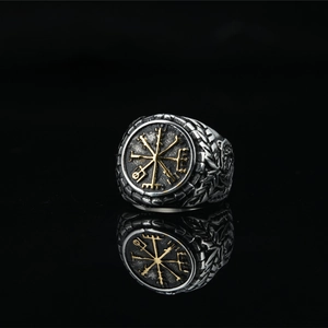 Men's vintage viking ring with golden compass pattern on a reflective black base
