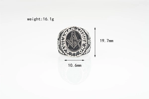 Macro shot of silver Freemason ring showing Masonic compass and letter G emblem detail