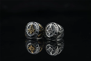 Macro shot of Freemason emblem and G logo on a vintage stainless steel men's ring