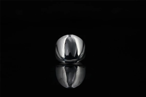 Close-up of polished silver punk ring featuring a solid square face with mirrored finish