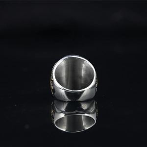 Vintage silver masonic ring for men with gold emblem on black reflective surface