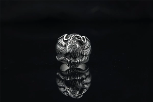 Detailed close-up of a vintage titanium steel eagle ring with oxidized black texture