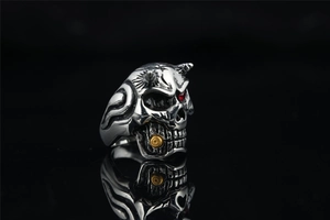 Close-up of gothic skull ring with red eye gemstone and gold teeth detail