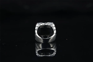 Detailed view of vintage silver ring with intricate woven texture and square top design