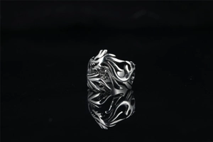 Detail shot of vintage dragon hollow pattern and honeycomb texture on silver steel ring