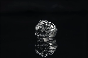 Detailed view of vintage silver eagle head ring with intricate feather texture and dark shadows