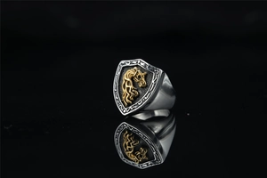 Detail view of vintage signet ring featuring a golden horse emblem on a black shield