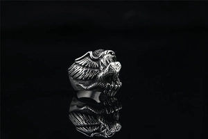 Macro shot of vintage eagle ring detailing feather textures and oxidised silver finish