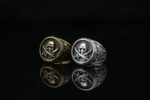 Detailed view of skull and crossbones emblem on vintage pirate style signet rings