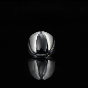 Polished silver punk style square signet ring for men on a black reflective surface