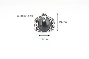Detail view of vintage titanium ring with large black agate stone and eagle claw setting