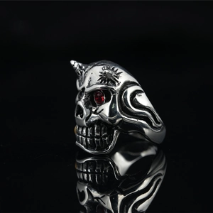 Vintage punk skull ring in antique silver with red gemstone eyes and horn details
