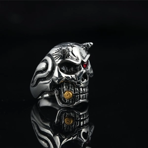 Vintage punk skull ring in silver titanium steel with red zircon eye and golden orb detail