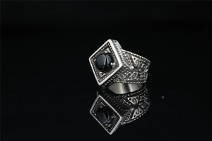 Detailed close-up of retro silver ring with square black agate stone on mirror base