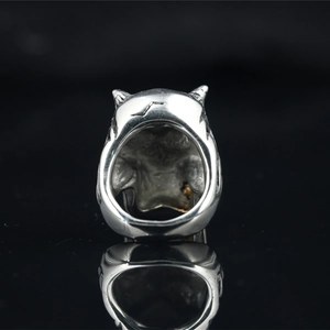 Vintage silver skull ring for men with heavy metal punk engraving on black background