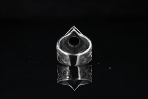 Macro detail of vintage punk signet ring with engraved silver metal patterns and reflection