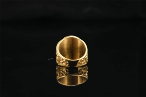 Macro detail of vintage gold Masonic ring with side floral relief and brushed metal interior