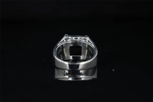 Macro shot of titanium steel ring featuring hollow geometric patterns and square setting