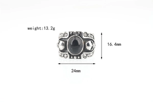 Detail view showing dimensions of a punk silver skull ring with a large black gemstone inlay