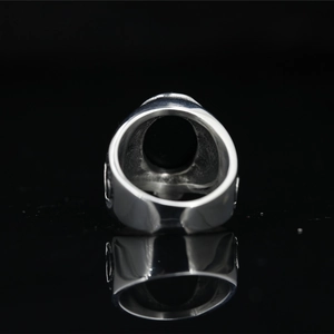 Men's vintage signet ring in polished silver titanium steel with reflective black background
