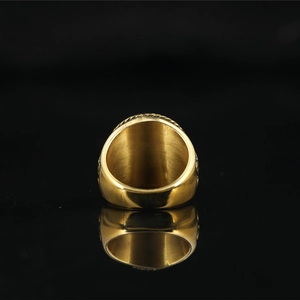 Vintage gold steel pirate skull signet ring with engraved relief on black mirror surface
