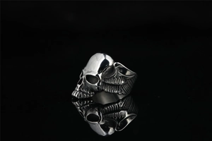 Macro view of vintage silver skull ring with wings in gothic stainless steel style